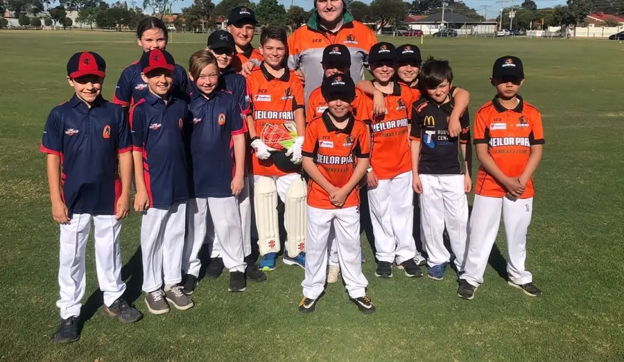 A Keilor Park junior team in orange and navy at the ground